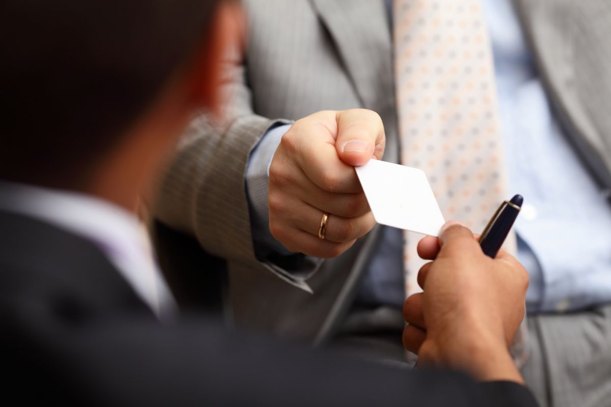 Closeup portrait of two successful business executive exchanging business card